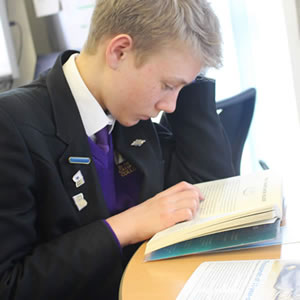 A boy with reading badges reading